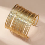 Åben armbåndsbeslag med spiral i guld